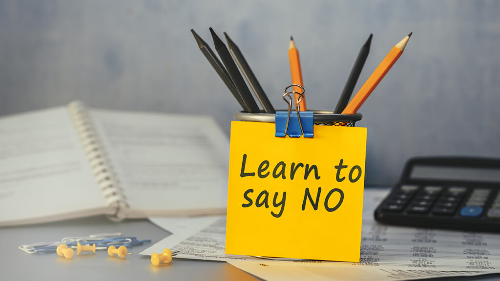 a post-it note that reads: Learn to say no